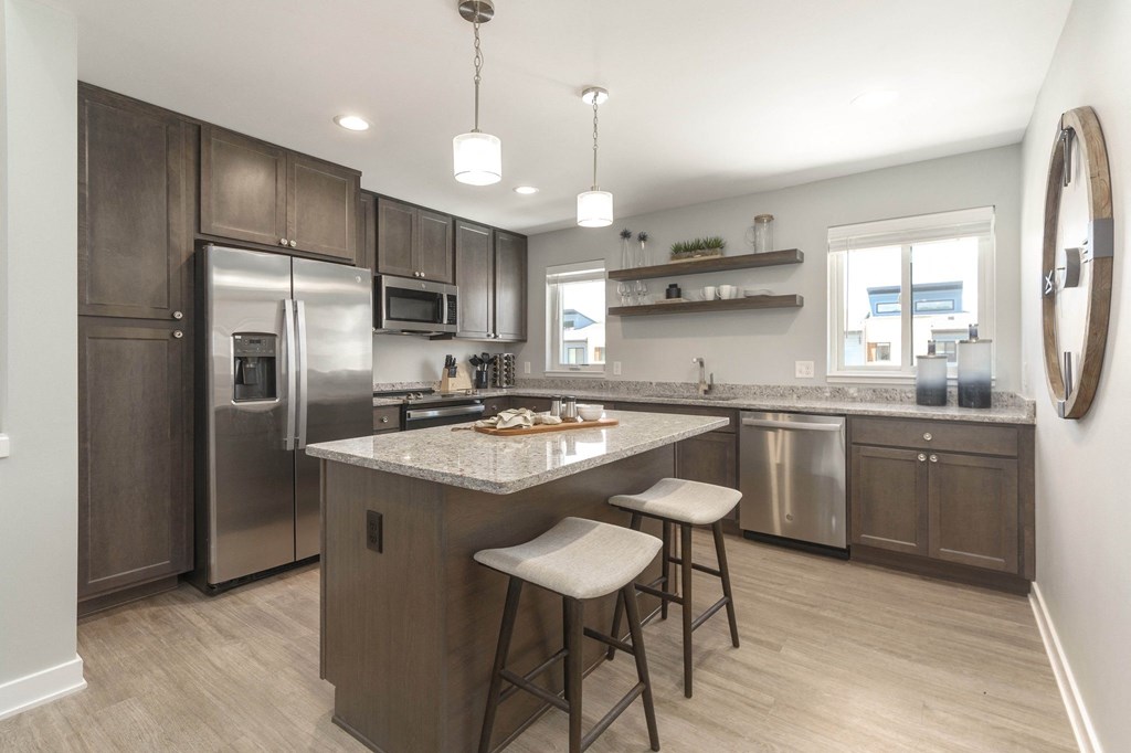 a kitchen with stainless steel appliances and a marble counter top